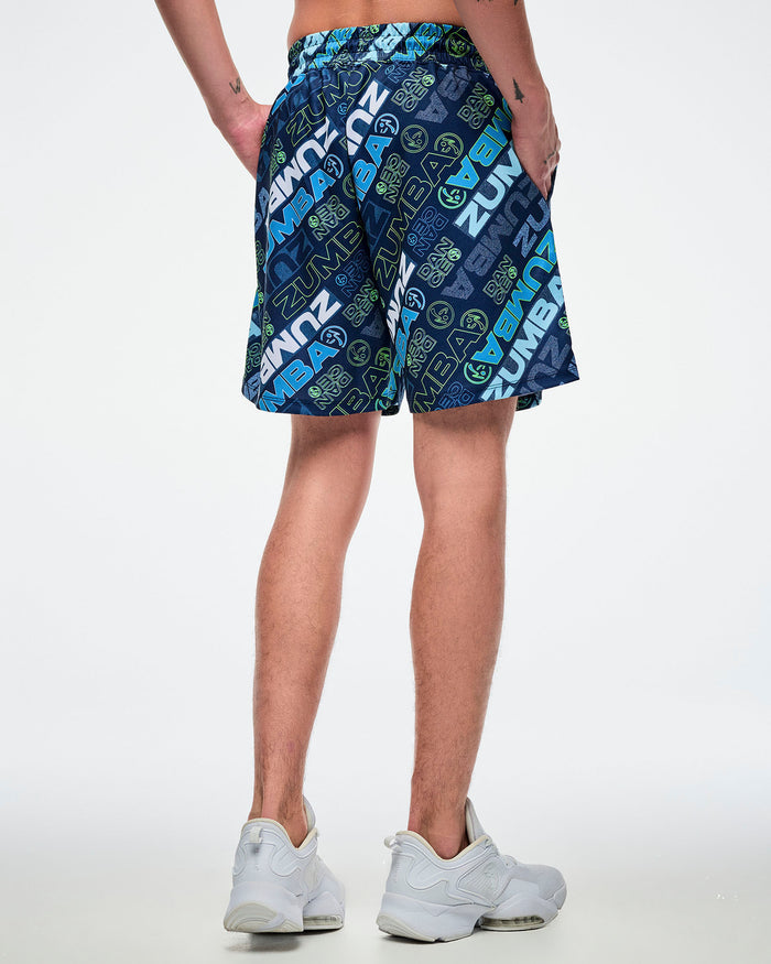 Back view of a male model wearing blue patterned shorts on a white background.