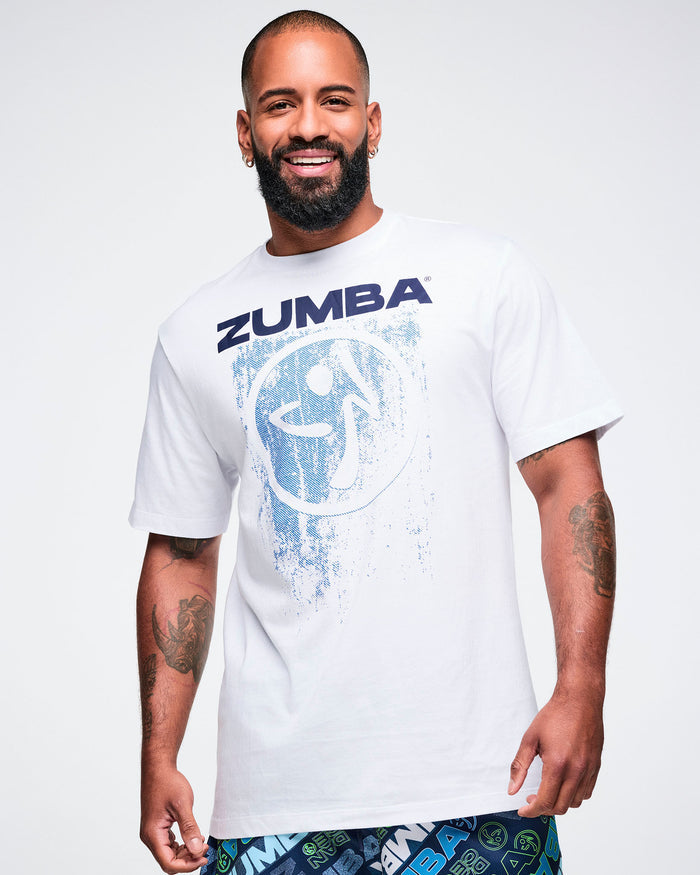 Male model wearing a white Zumba t-shirt on a plain background.