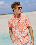 The lifestyle view of the Southern Tide Kokomo Row Linen Rayon Short Sleeve Sport Shirt by Southern Tide - Orange Blossom