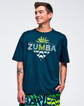 Dark teal oversized graphic T-shirt with “ZUMBA” text, small slogan above, and a lime sunburst with wave graphic below, worn by a male model with green patterned shorts.