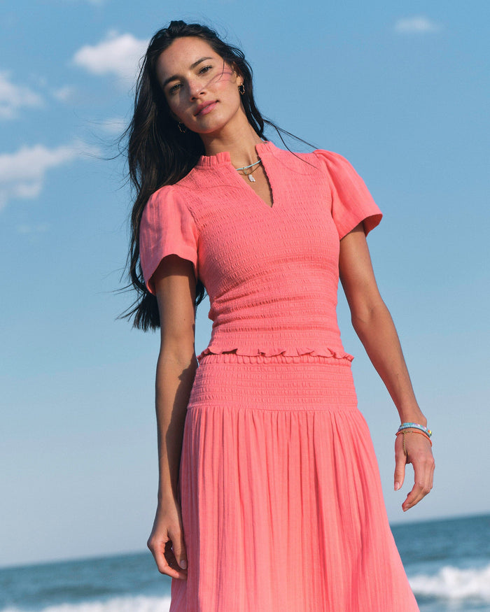 The lifestyle view of the Southern Tide Lola Smocked Bodice Top by Southern Tide - Coral Beach