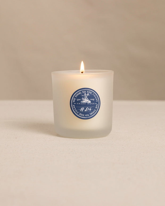 The front view of the We Took to the Woods Low Tide 10:22 Candle at Southern Tide - White