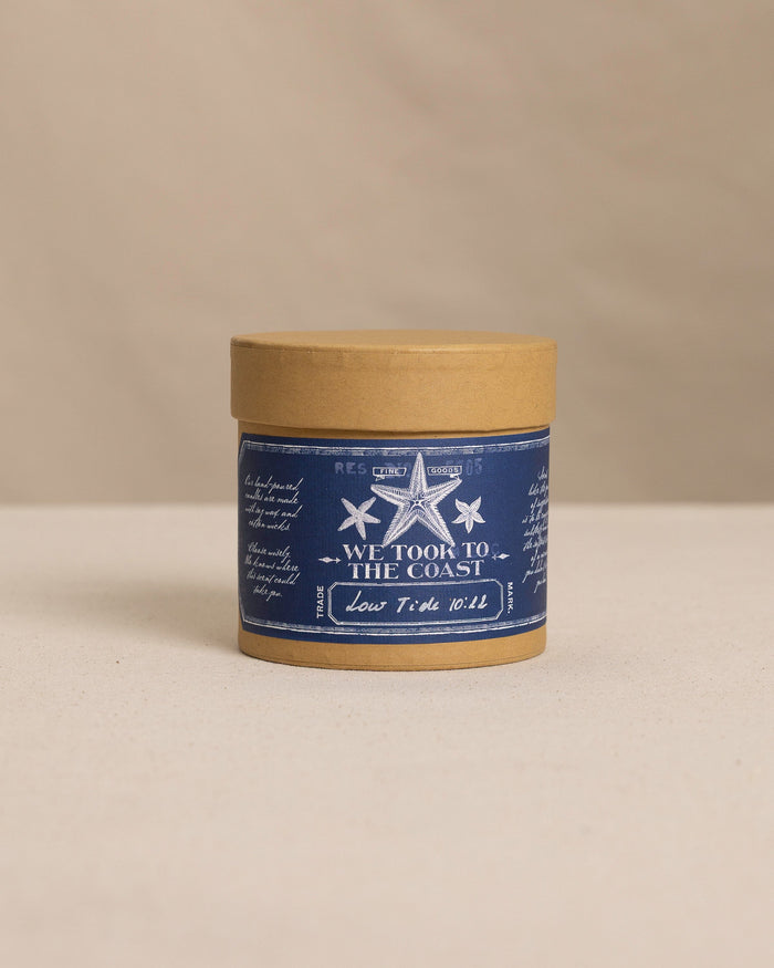 The front view of the We Took to the Woods Low Tide 10:22 Candle at Southern Tide - White