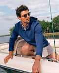 The lifestyle view of the Southern Tide Ottoman Heather Quarter Zip Hoodie by Southern Tide - Heather Nautical Blue
