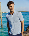The lifestyle view of the Southern Tide Pelican Landing Stripe Coastal Breeze® Performance Polo by Southern Tide - Ocean Channel