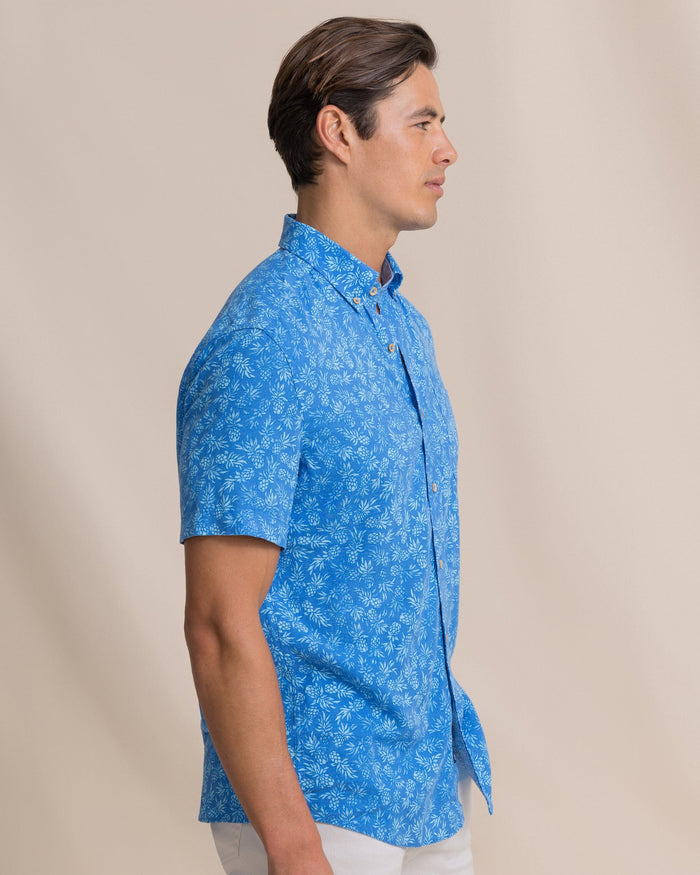 The side view of the Southern Tide Pineapple Parade Linen Rayon Short Sleeve Sport Shirt by Southern Tide - Blue Stream