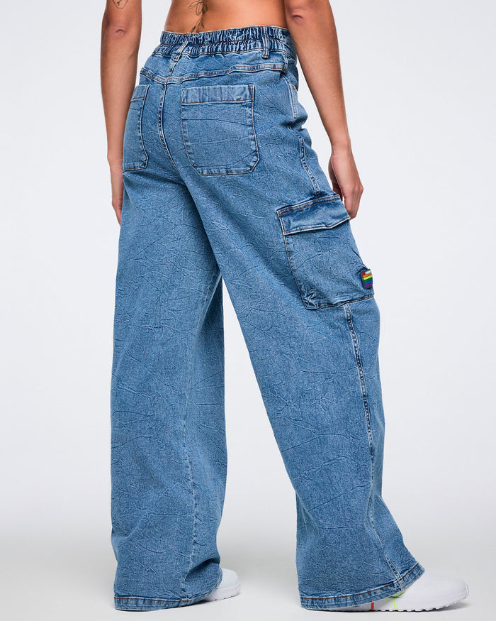 Female model shown from the back wearing denim cargo pants with visible back pockets and side cargo pocket against a white background.