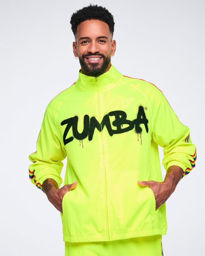 Male model wearing a zipped up bright yellow 'Zumba' jacket on a white background.