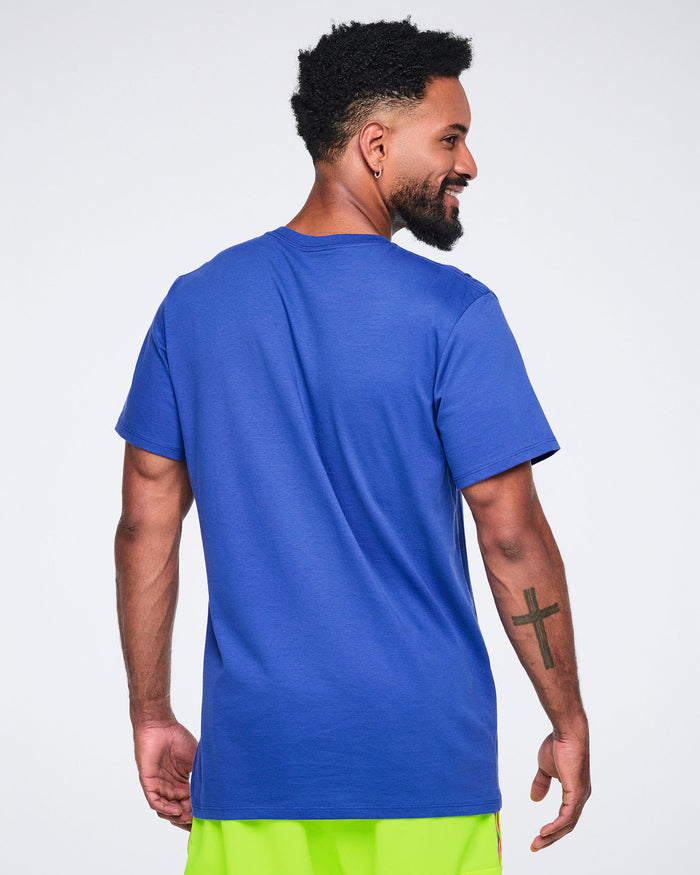 Back view of a male model wearing a blue t-shirt on a white background.