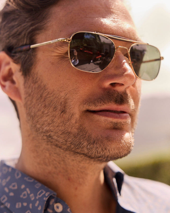 The lifestyle view of the Southern Tide Quarter Deck Aviator by Southern Tide - Yellow Gold Frame with American Green Lens