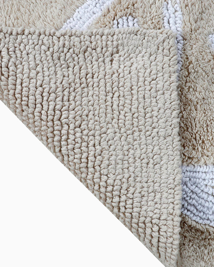 The flip view of the Reversible Skipjack Bath Rug by Southern Tide - Sand