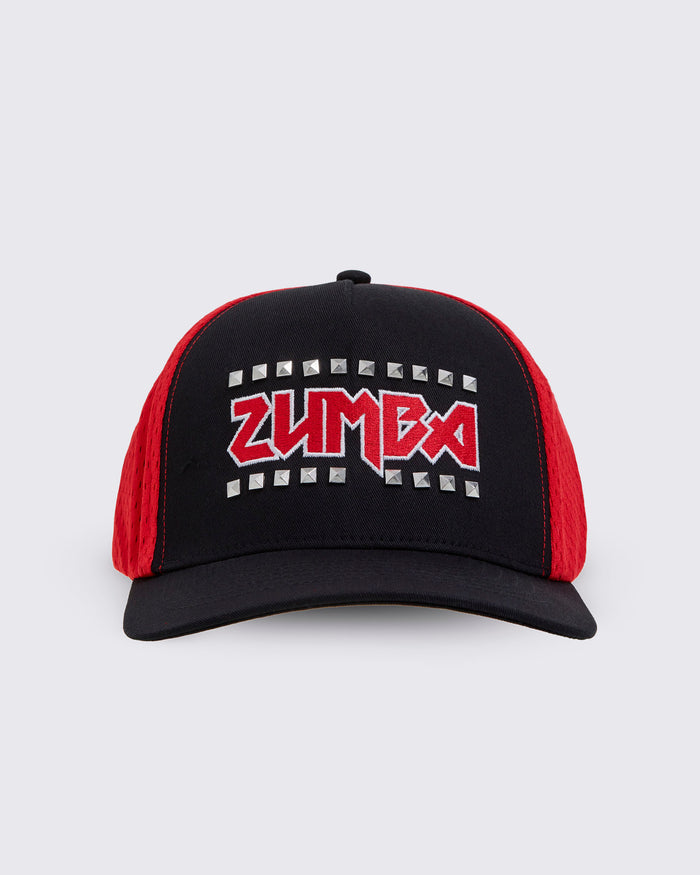 A black trucker-style hat with red mesh side panels and a red embroidered ZUMBA logo outlined in silver studs on the front.