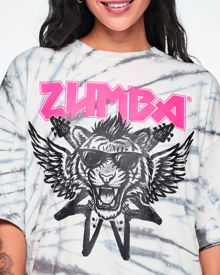 Close-up of the pink 'ZUMBA' rock-like text and a black and white image of a tiger in sunglasses with guitars and angel wings behind.