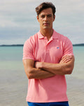 The lifestyle view of the Southern Tide Skipjack Polo Shirt by Southern Tide - Sea Pink