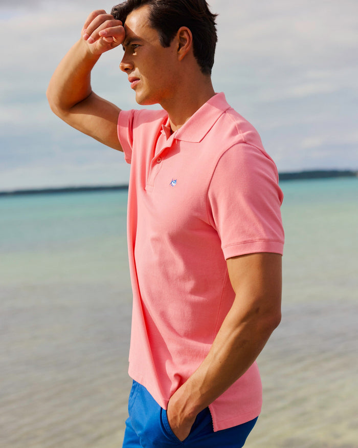 The lifestyle view of the Southern Tide Skipjack Polo Shirt by Southern Tide - Sea Pink