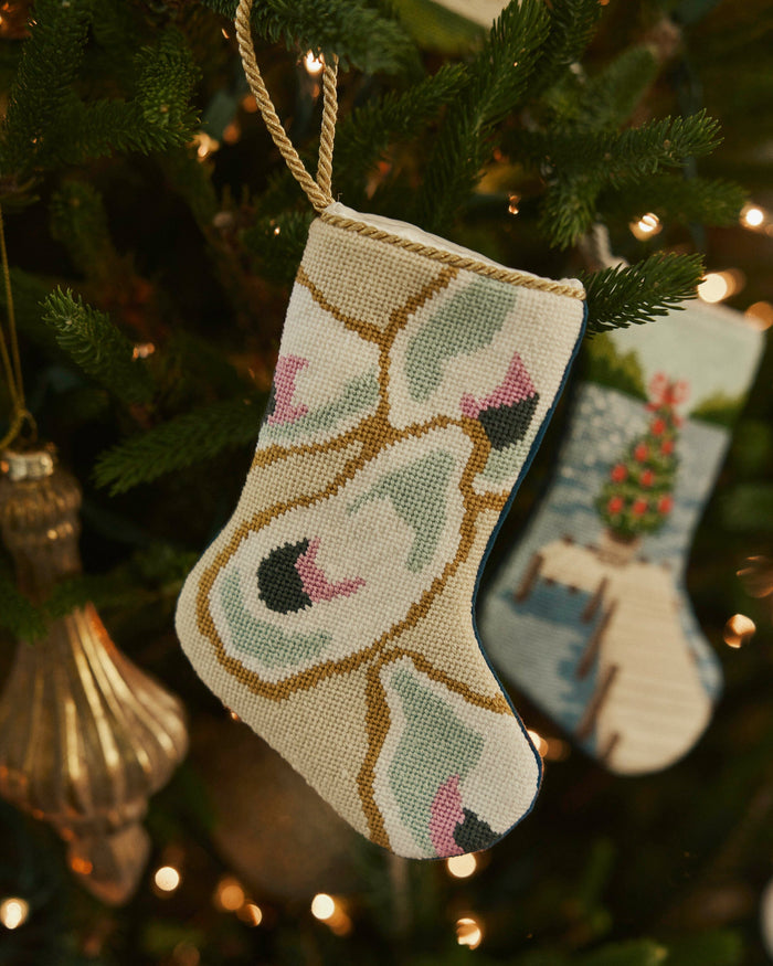 The lifestyle view of the Southern Tide Southern Oyster Needlepoint Stocking by Southern Tide - White