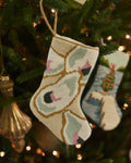 The lifestyle view of the Southern Tide Southern Oyster Needlepoint Stocking by Southern Tide - White