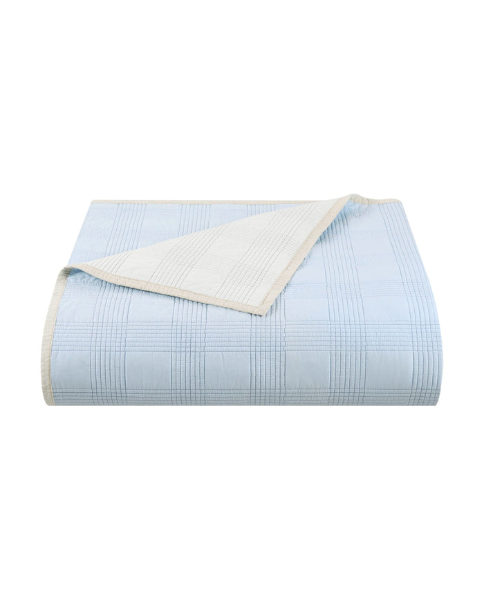 The front view of the Southern Tide Camden Quilt by Southern Tide - Ivory/Blue