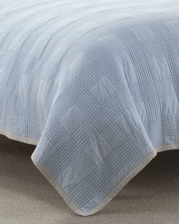 The front view of the Southern Tide Camden Quilt by Southern Tide - Ivory/Blue