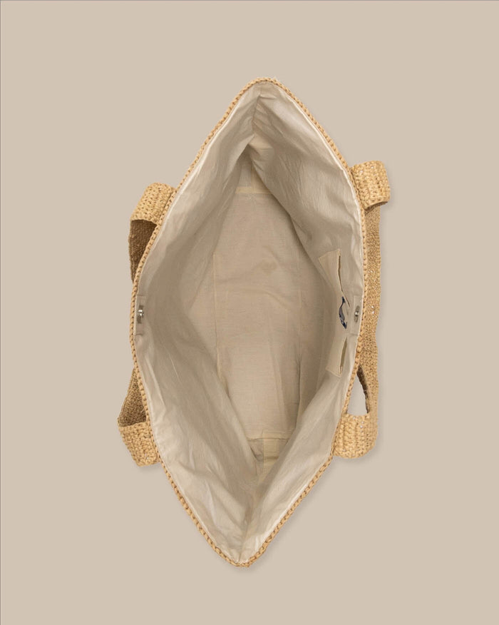 The detail view of the Southern Tide Striped Straw Hat Carrier Beach Tote by Southern Tide - Navy