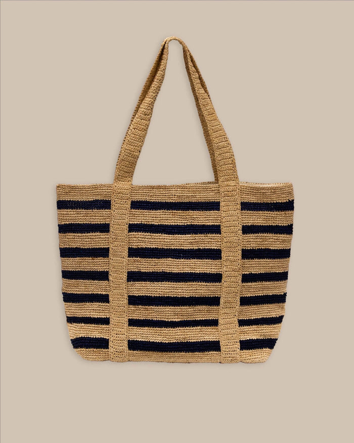 The back view of the Southern Tide Striped Straw Hat Carrier Beach Tote by Southern Tide - Navy
