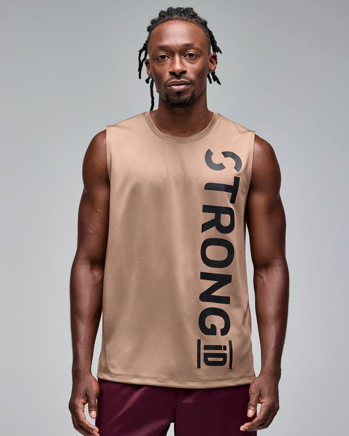 Taupe sleeveless athletic tank with a crew neckline and oversized vertical black "STRONG iD" logo, shown on a male model wearing burgundy athletic shorts against a light gray studio background.