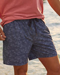 The lifestyle view of the Southern Tide Tide To The Shore Swim Trunk by Southern Tide - Light Indigo