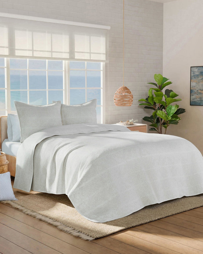 The side view of the Southern Tide Tideline Coverlet Quilt by Southern Tide - White Sand