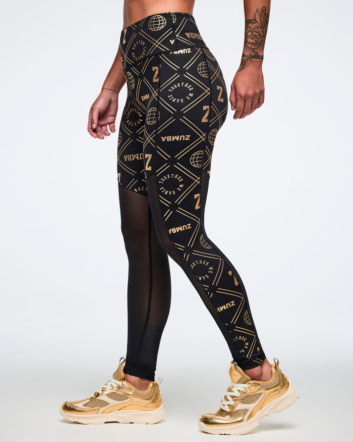 Female model wearing black leggings with gold geometric pattern paired with gold shoes.