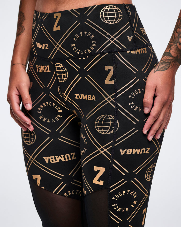 Close-up of Zumba leggings with gold patterns on a white background.