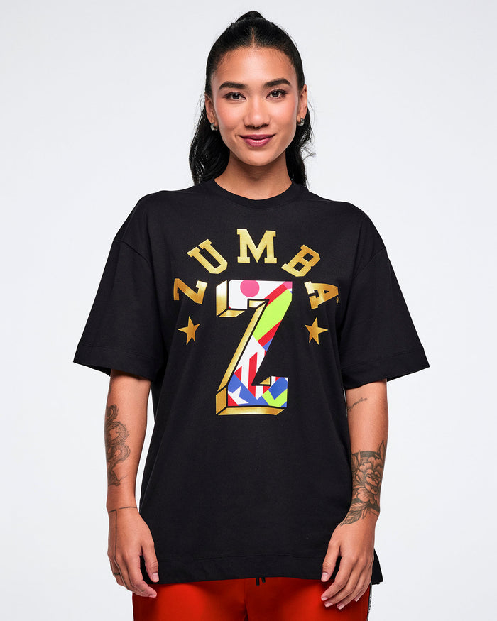 Female model wearing a black t-shirt with colorful 'Zumba' logo on a white background.