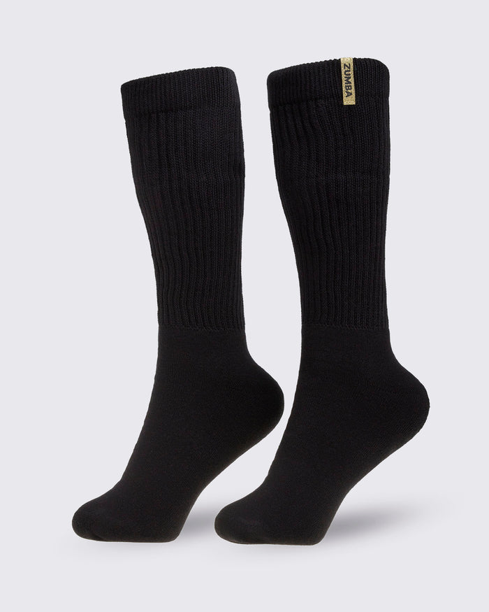 Pair of black socks with a brand Zumba logo in gold, on a white background.