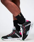Zumba shoes worn with black socks on a white background.