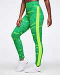 Female model wearing green leggings with a Zumba pattern and yellow stripe on a white background.