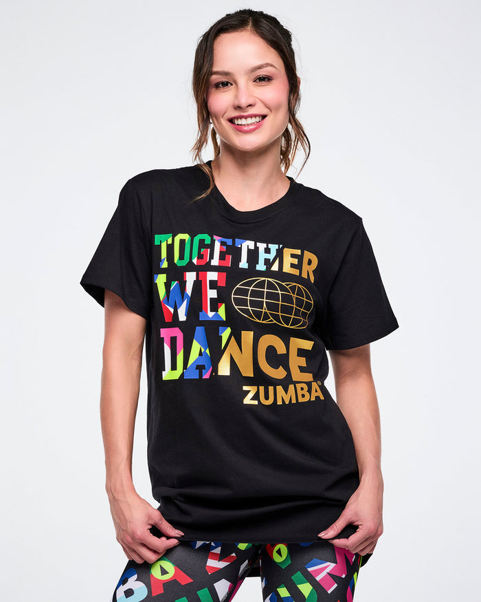 Female model wearing a black Zumba t-shirt with colorful text on a white background.
