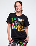 Female model wearing a black Zumba t-shirt with colorful text on a white background.