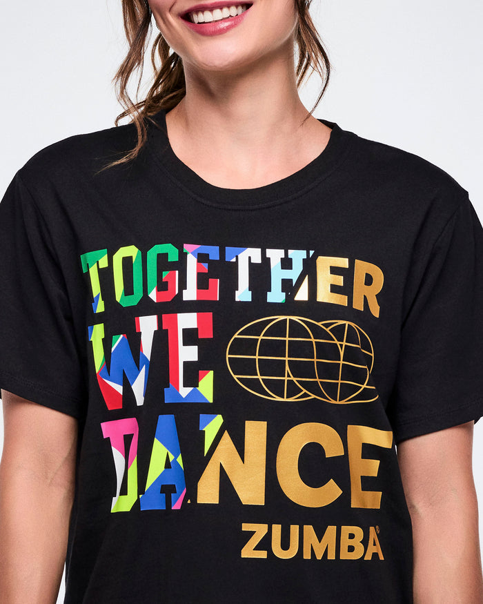 Close view of female model wearing a black Zumba t-shirt with colorful text on a white background.
