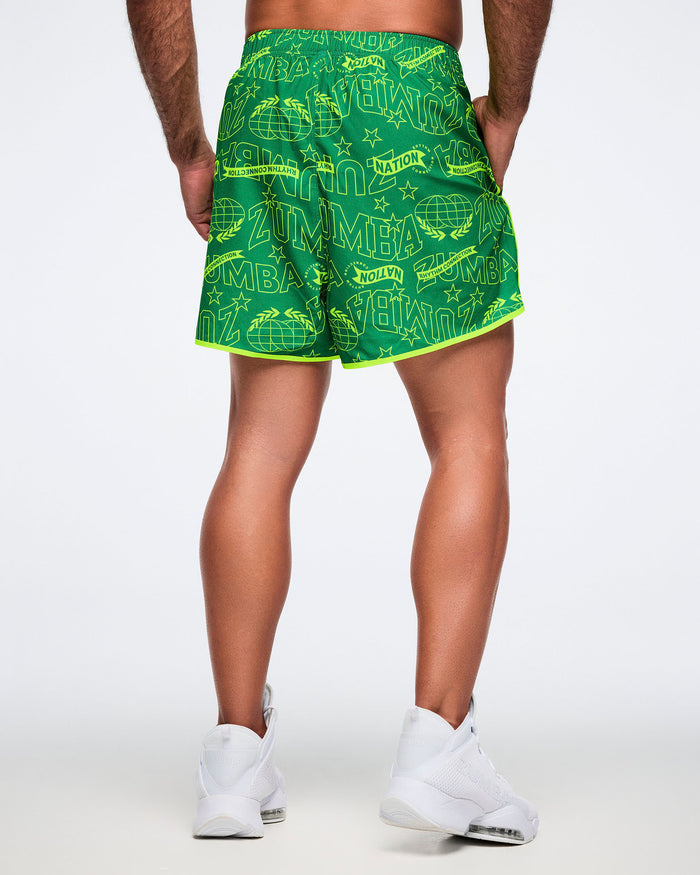 Male model, shown from the back, in green and yellow patterned shorts.