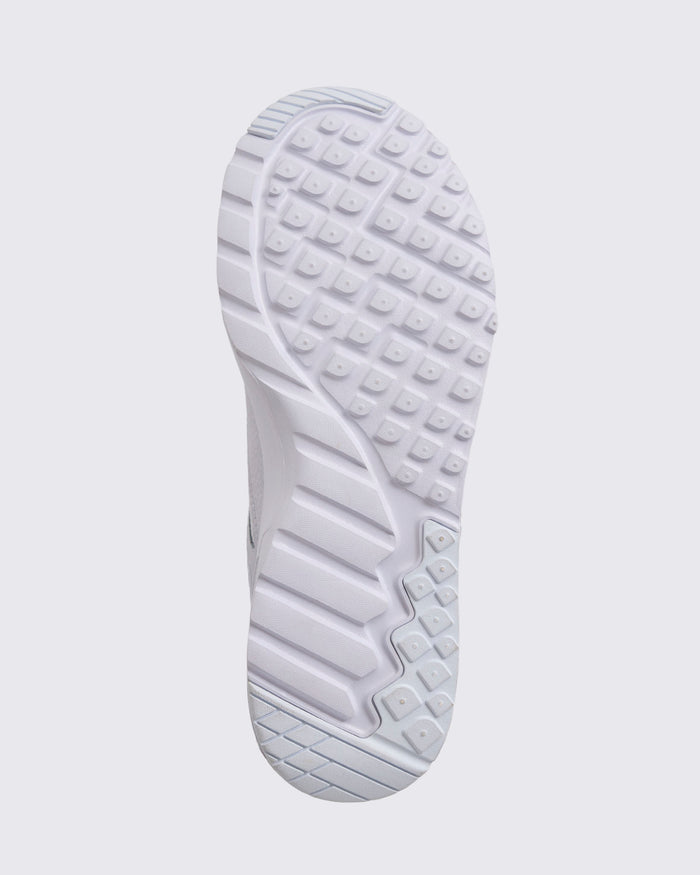 White Zumba sneaker outsole view, highlighting the full tread pattern with square grip lugs, flex grooves, and a cushioned sole.
