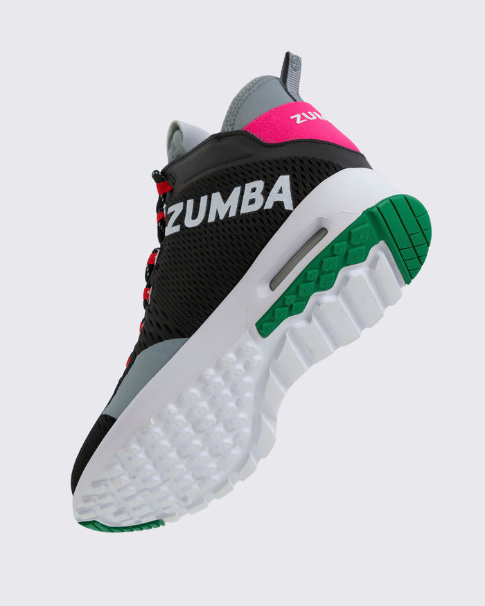 Zumba sneaker bottom side view, with black, gray, pink, and green design on a white background.