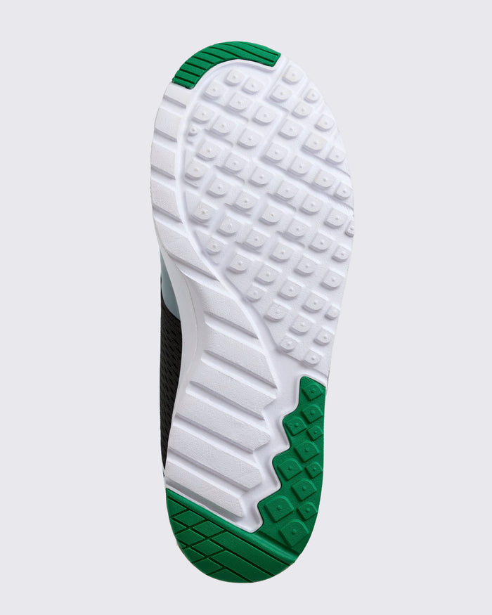 Sole view close-up with white and green tread pattern on a light background.