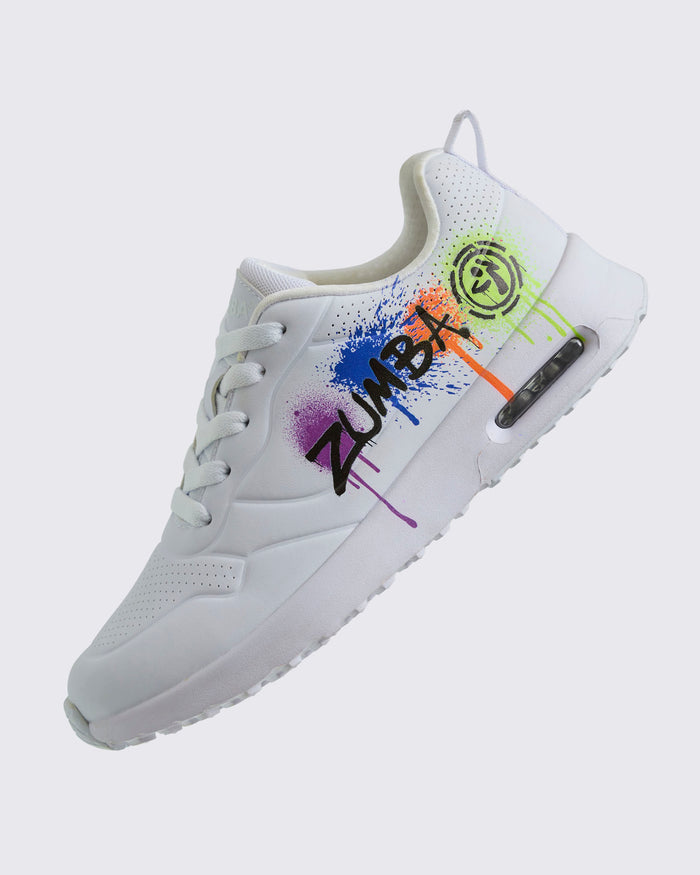 Side view of a white sneaker featuring colorful graffiti-style accents and “Zumba” in black text on a white background.
