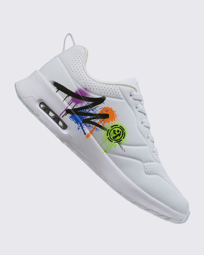 Side view of a white sneaker featuring a colorful graffiti-style Zumba design and a Zumbito logo on a white background.