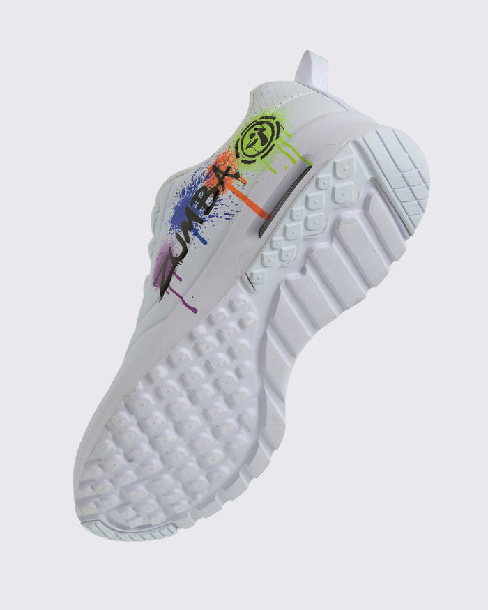 Angled view of a white Zumba sneaker with colorful design showing the patterned sole on a white background.