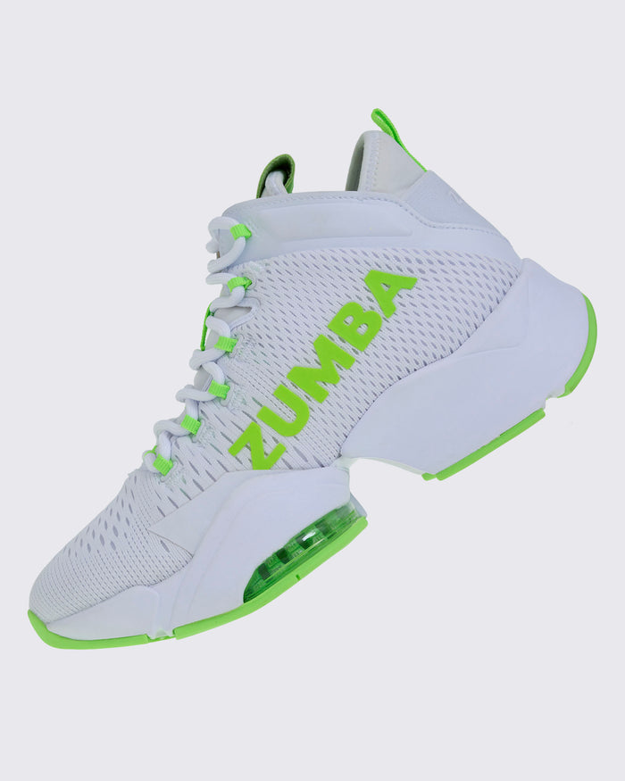 Left-side view of a white and green Zumba sneaker with “ZUMBA” in green, green-accented laces and sole, and a rear pull loop.