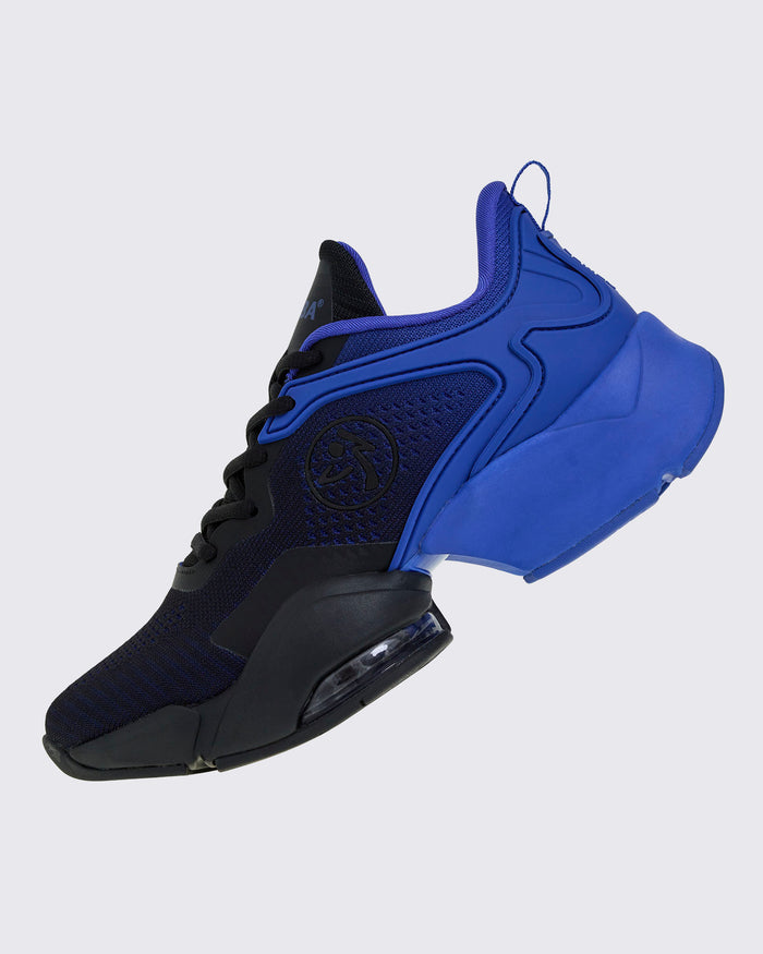 Left side view of blue-and-black Zumba sneaker with the black Zumbito in the center.