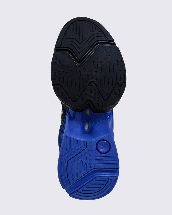 Bottom view showing split black-and-blue outsole with multidirectional traction pattern.
