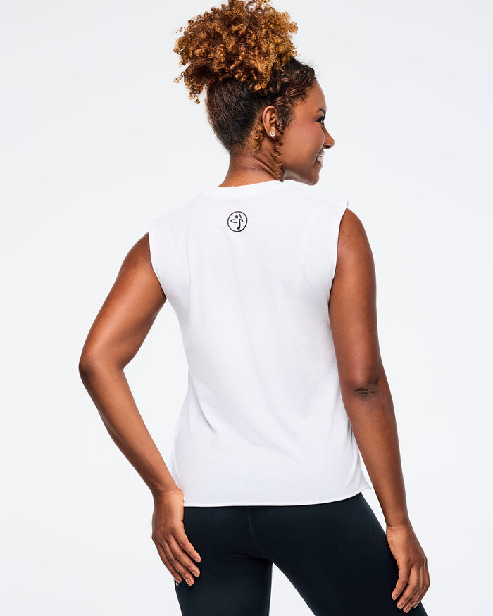 Back view of a female model wearing a Zumba sleeveless tank and leggings on a white background.