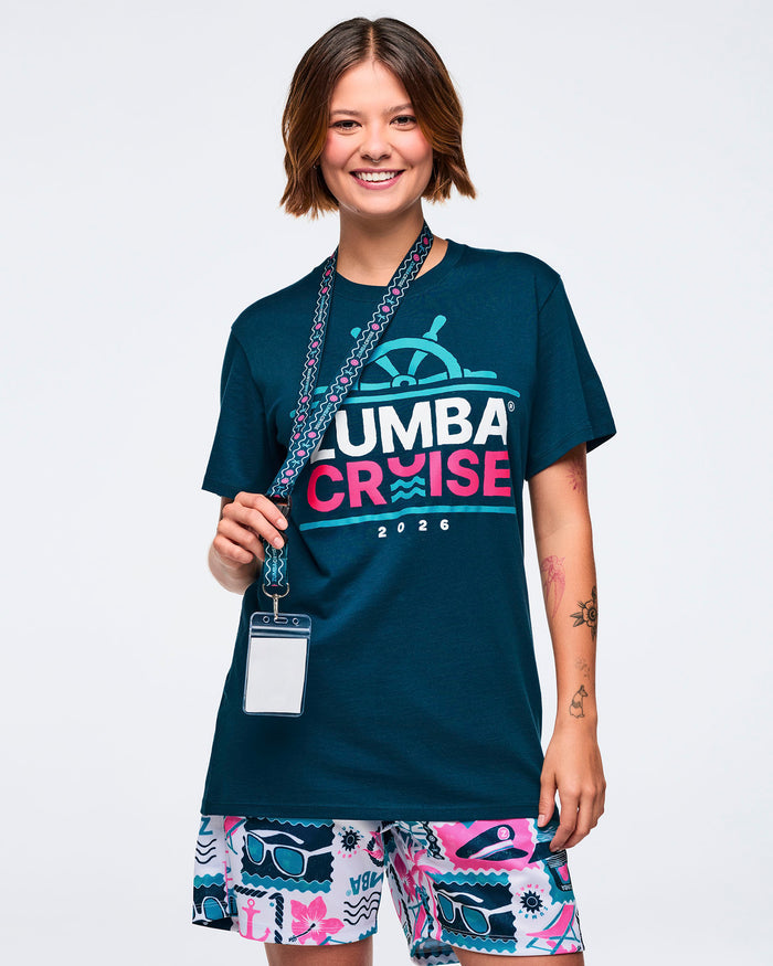 Female model wearing a blue t-shirt with colorful shorts and holding a lanyard on a white background.