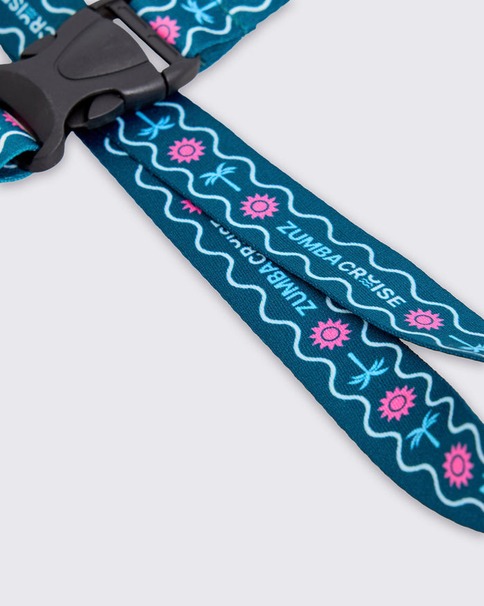 Close-up of the blue lanyard Zumba Cruise strap with pink floral patterns and white text.